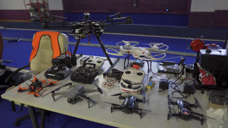 Drones-and-UAV-aircraft-neatly-organised-on-a-bench-indoors-at-vocational-high-school