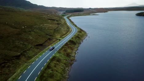 car-driving-by-a-bay-in-Ireland,-Dingle-Peninsula