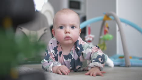 Baby-crawls-on-floor-toward-camera,-slow-motion