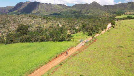 aerial-view-of-cyclists-on-trail-in-Serra-da-Canastra,-Minas-Gerais,-Brazil