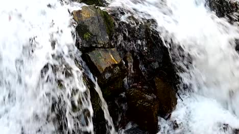 footage-of-fast-water-flowing-over-rocks-in-the-mountain