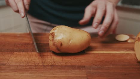 Chef-slices-off-potato-sides-to-prepare-potato-thick-chips