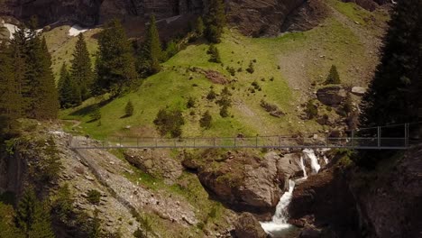 Bridge-that-crosses-a-river,-zoom-in-with-a-drone