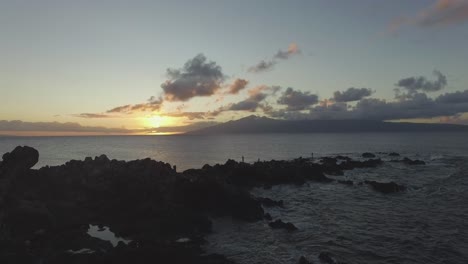 Maui,-HI-island-sunset-over-rocky-coastline-drone-4k