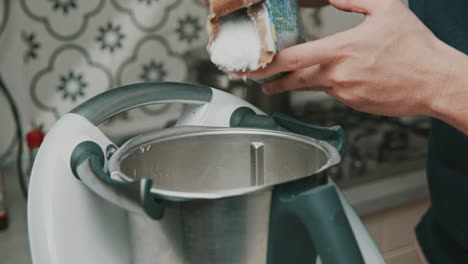 Chef-adds-a-lot-of-salt-into-kitchen-mixer