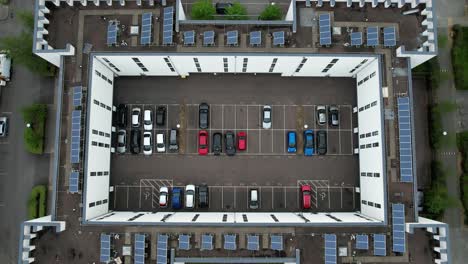 Aerial-view-above-energy-efficient-high-rise-complex-solar-panels-on-private-carpark
