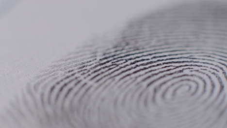 Extreme-Close-Up-Of-Fingerprint-Being-Applied-To-Paper-With-Camera-Panning