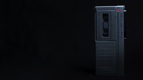 Full-Shot-Of-Microcassette-Recorder-Standing-Upright-Under-Low-Key-Blue-Light