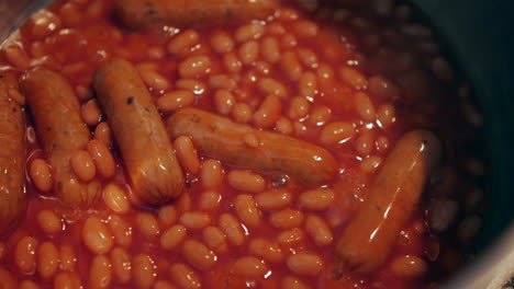 Close-up-of-Baked-beans-and-sausages-cooking-in-a-saucepan