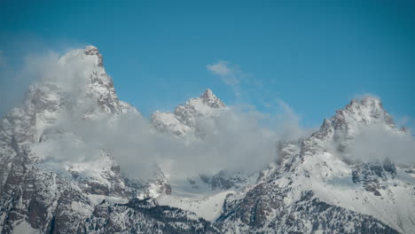 Time-Lapse,-Clouds-Formations-Above-Snow-Capped-Peaks-of-Grand-Teton-Mountain-Range-on-SUnny-Winter-Day