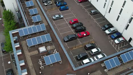 Aerial-view-above-renewable-energy-solar-productive-panels-with-inner-carpark-orbit-right-shot