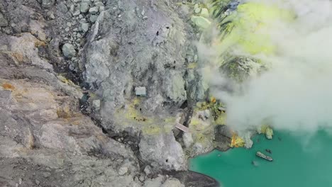 Dramatic-aerial-view-of-a-crater-acid-lake-Kawah-Ijen-where-sulfur-is-mined