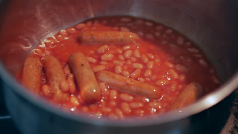 Baked-beans-and-sausages-cooking-in-a-saucepan