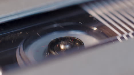 Extreme-Close-Up-Of-Microcassette-Recorder-Reel