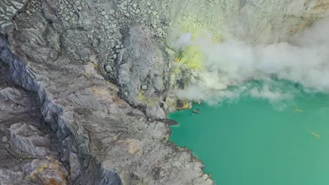 Dramatic-aerial-view-of-a-crater-acid-lake-Kawah-Ijen-where-sulfur-is-mined