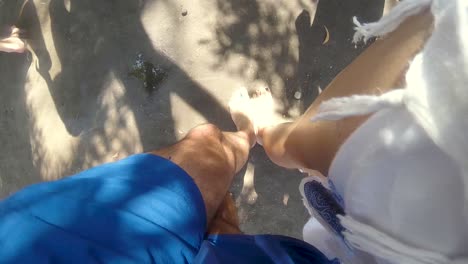 Comparing-man's-and-woman's-feet-barefoot,-POV