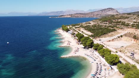 Ksamil-Beach,-Albania---Popular-Summer-Holiday-Destination---Reversing-Aerial