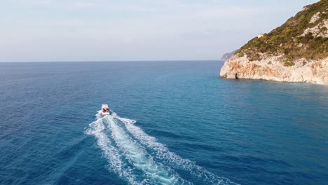 Taxi-Boat-from-Milos-Beach-to-Agios-Nikitas-at-Lefkada-Island,-Greece---Aerial