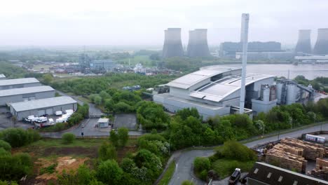 Industrial-power-station-warehouse-complex-site-with-green-space-ecological-park-land-aerial-view-panning-left