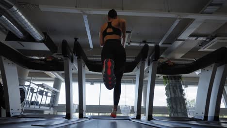 Woman-running-on-a-treadmill-in-a-gym