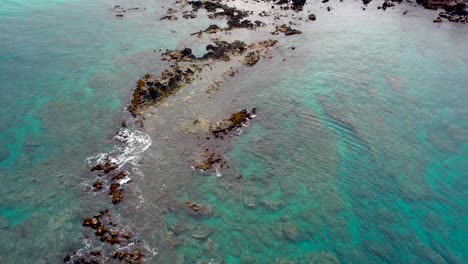 Luftaufnahme-über-Weißen-Waschwellen-Auf-Lavafelsen-Und-Riff-Im-Klaren-Türkisfarbenen-Ozean-In-Hawaii