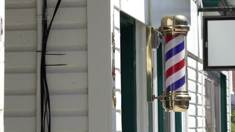 Barber-pole-revolves-on-clapboard-building-with-coax-cables