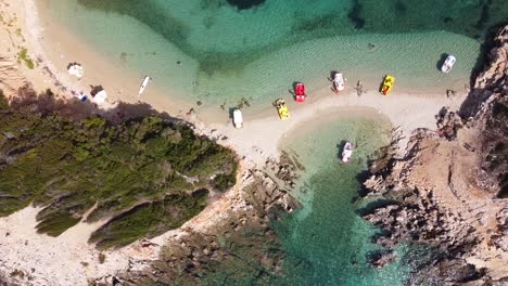 Pedal-Boats-and-Small-White-Sandy-Beach-at-Ksamil-Islands,-Albania---Aerial-Top-Down-Descending