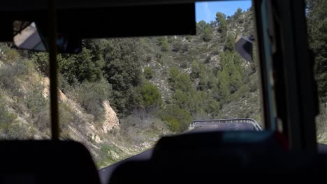 POV-of-interior-of-bus-driving-through-Mediterranean-countryside