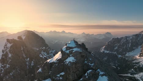 Mountaineer-standing-on-a-peak-in-the-Dolomites-at-sunrise