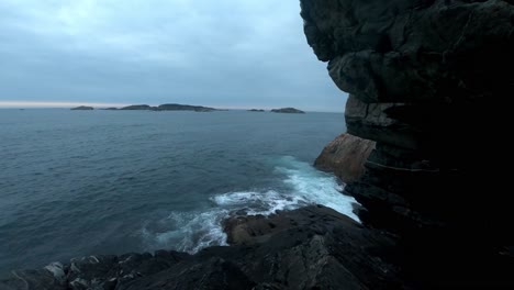 Ocean-timelapse-with-waves-washing-up-on-rocky-cliff-close-to-camera---Telavaag-Norway-in-the-evening-with-North-sea-background