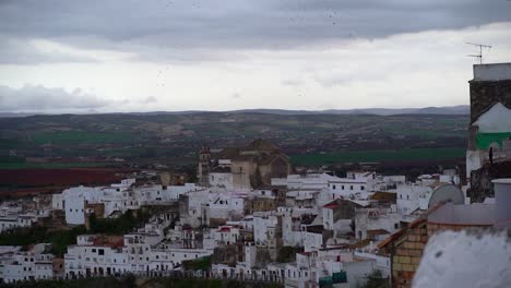 Panoramic-view-at-dusk-over-whitewashed-houses-of-Arcos-de-la-Frontera-in-Andalusia,-Spain