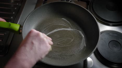 Cast-iron-Pan-Heating-On-The-Stove-And-Greased-With-Butter