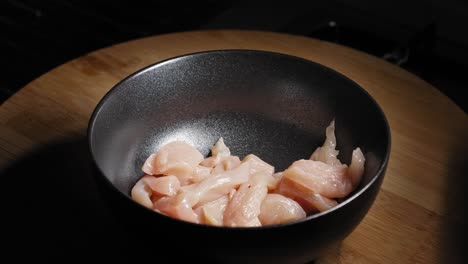 Slices-Of-Fresh-Chicken-Breast-Dropping-Into-Bowl