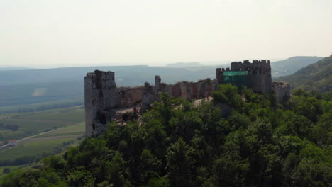 Ruins-of-stone-Děvičky-castle-on-hilltop-in-Moravia,-drone-shot