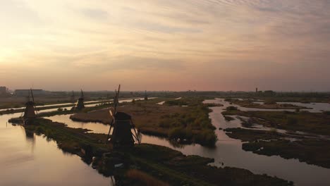 drone-shot-slowly-rotating-to-the-left-at-the-windmills-of-Kinderdijk-at-sunset-in-4K