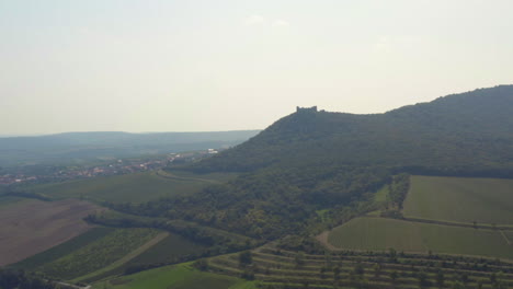 Děvičky-castle-on-hilltop-overlooking-moravian-countryside,-drone-shot