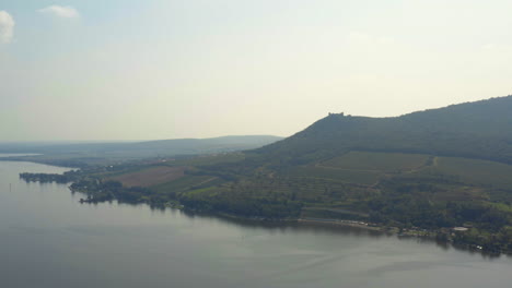 Děvičky-hill-castle-above-Věstonice-reservoir-in-Moravia,-drone-shot