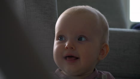 closeup-of-a-happy-blue-eyed-baby-girl-sitting-up