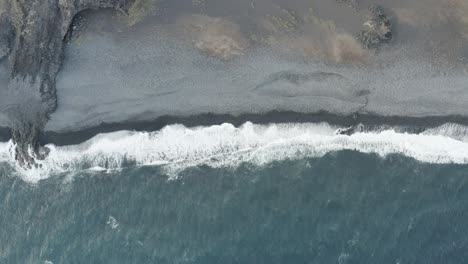Puerto-Rico-aerial-top-down-view-of-ocean-waves-crashing-on-black-sand-beach-,-tropical-dreaming-seascape-paradise