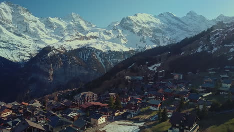 Aerial-footage-of-Swiss-mountain-village-of-Mürren-with-towering-mountains