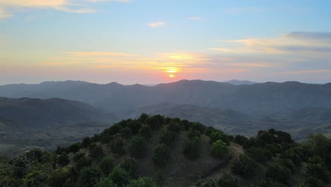 rotate-aerial-drone-view-of-hills-with-sunrise-background