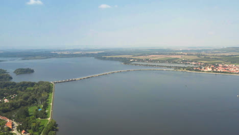 Causeway-over-Věstonice-reservoir-connecting-towns-on-shores,-drone
