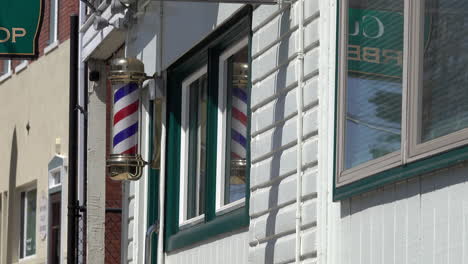 Barber-pole-turning-on-front-of-barber-shop-building