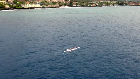 Aerial-of-Hawaiian-canoe-rowing-team-paddles-in-Pacific-ocean-in-synchrony