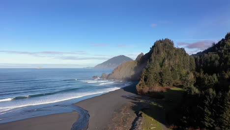 Drone-rises-over-empty-Oregon-Coast-beach-in-morning-light