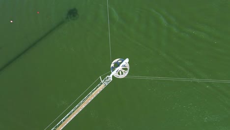 Birds-eye-view-drone-shot-of-a-waterski-system---drone-is-watching-an-active-rotor