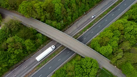Aerial-view-of-cars-and-lorries-passing-under-a-bridge-over-the-A2-dual-carriage-way-in-Canterbury