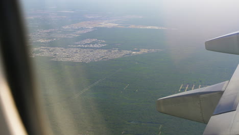 Airplane-Flying-Over-Tropical-Rainforest-Jungle-Landscape-Near-Cancun-City-Limits-Outskirts