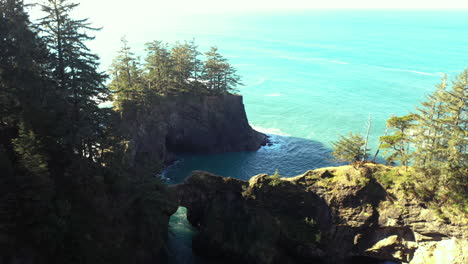 Brookings,-Oregon,-drone-flyover-Natural-Bridges-rock-formation