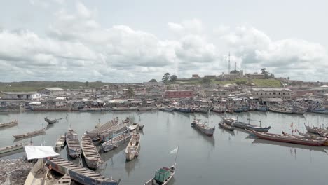 Aerial-shot-of-a-settlement-along-the-coast-in-Africa,-Ghana,-Elmina